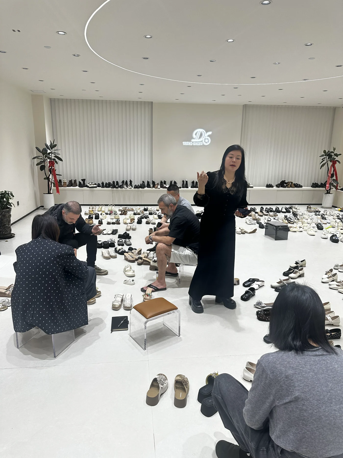 Overseas customers selecting women shoe samples in the showroom